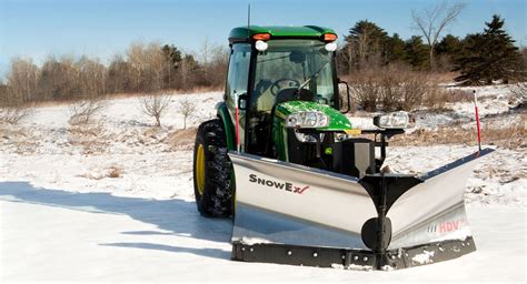 snow plow mounted to tractor